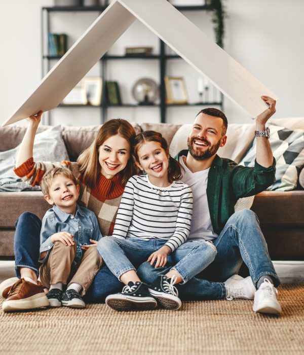 concept housing a young family. mother father and children in new home concept housing a young family. mother father and children in a new home